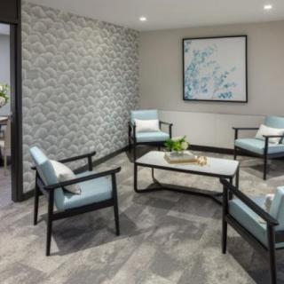 A modern waiting room featuring elegant seating and decorative elements.