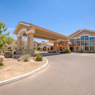 A welcoming hotel entrance with modern architecture and landscaped surroundings.