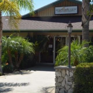 Entrance to a restaurant surrounded by palm trees.