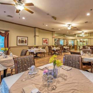 A cozy dining room with neatly arranged tables and elegant decor.