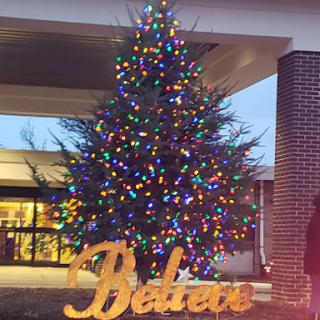A beautifully lit Christmas tree displayed outside, with the word 'Belair' in front.