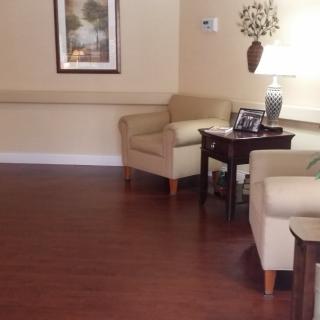 A cozy living room with chairs, a table, and decorative items.