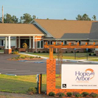 A well-maintained facility with a prominent entrance sign and landscaped surroundings.