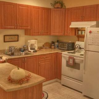 A cozy kitchen with wooden cabinets and modern appliances.