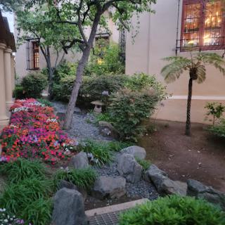 A serene garden path adorned with colorful flowers and lush greenery.
