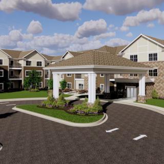 A modern residential building with a landscaped entrance and driveway under a cloudy sky.