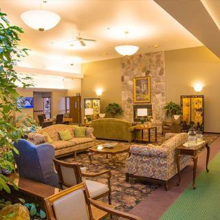 A comfortable and elegantly decorated lobby with various seating arrangements and warm lighting.