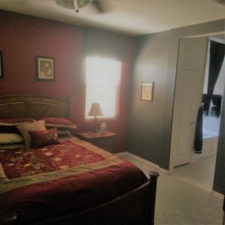 A cozy bedroom featuring warm tones and comfortable bedding.