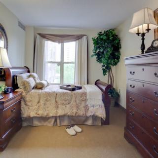 A cozy bedroom with traditional furniture and elegant decor.