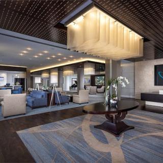 A modern hotel lobby featuring elegant furnishings and stylish lighting.