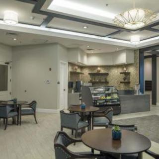 A modern cafe interior with seating area and counter.