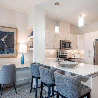 A modern kitchen with sleek appliances and a stylish dining area.