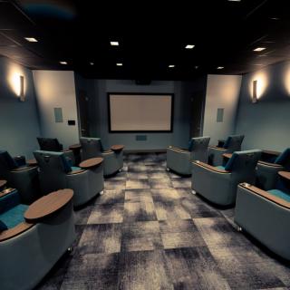 A modern home theater setup with comfortable seating and a large screen.