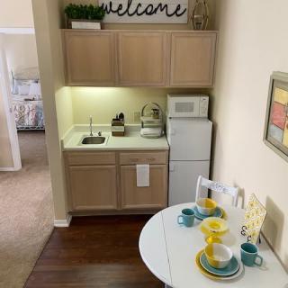 A cozy apartment kitchen with a small dining area, featuring modern decor and a welcoming atmosphere.