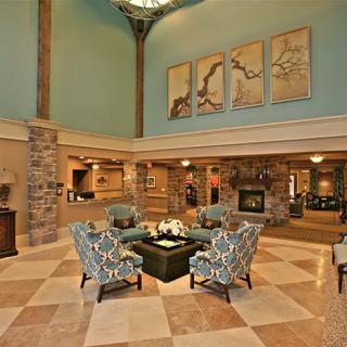 A beautifully decorated lobby with a comfortable seating area and elegant artwork on the walls.