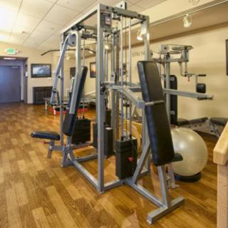 A well-equipped gym with various exercise machines for strength training.