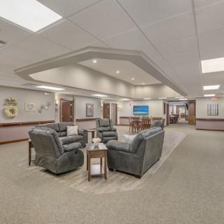A spacious office waiting area with comfortable seating and modern interior design.