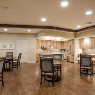 A modern kitchen and dining area with wooden flooring and elegant furnishings.