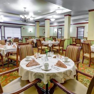 An elegantly set dining room with neatly arranged tables and chairs.