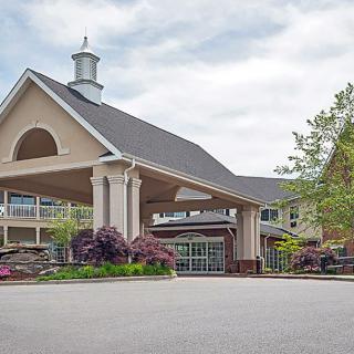 A welcoming building entrance with landscaped surroundings.