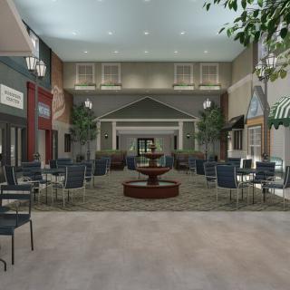 An indoor seating area with a central fountain, surrounded by tables and chairs, decorative lighting, and potted plants.