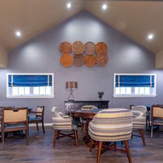A modern living room with stylish seating and blue accents.