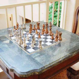A beautiful wooden table with a chess game set up, ready for play.
