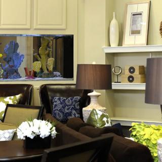 A stylish living room with modern decor, featuring elegant lamps and decorative shelving.