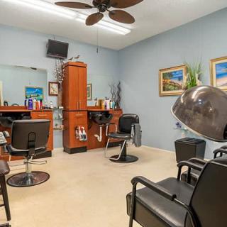 An interior view of a hair salon with styling stations and chairs.