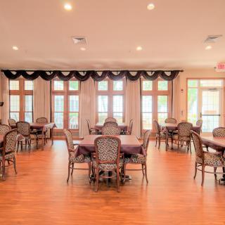 Spacious dining room with elegant decor and large windows.