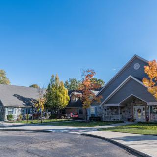 A suburban residential building surrounded by trees in autumn.