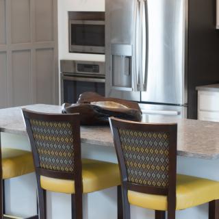 Modern kitchen with stainless steel appliances and a central island with seating.