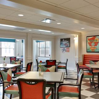 A cozy dining area featuring modern furniture and a bright, inviting atmosphere.