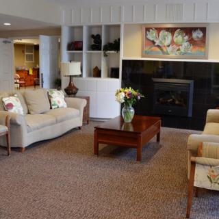 A well-decorated living room with comfortable seating and a fireplace.