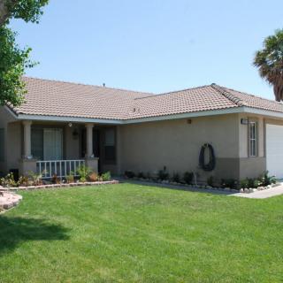 A suburban house with a well-maintained lawn and garden.