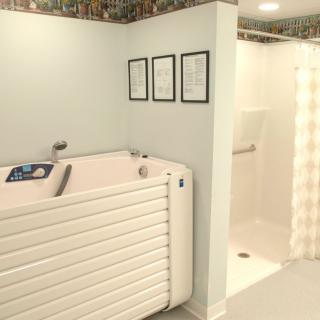 A bathroom featuring a walk-in tub and a separate shower stall, designed for accessibility.