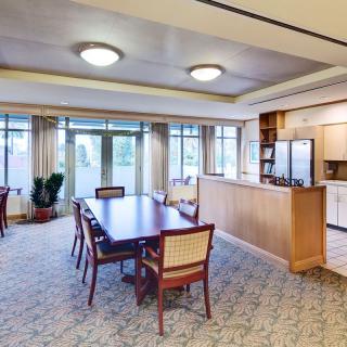 Spacious dining and kitchen area with large windows and elegant furnishings.