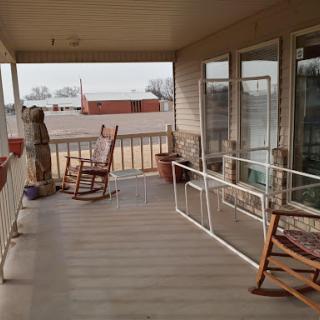 A peaceful porch with rocking chairs, perfect for relaxation in a rural setting.
