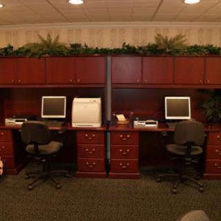 A neatly organized office workspace with two desks and computers.