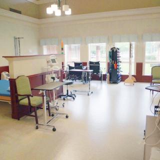A well-equipped rehabilitation room with various therapy and exercise equipment.