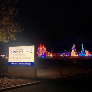 A vibrant display of colorful lights at night, featuring the Sapphire sign in front.