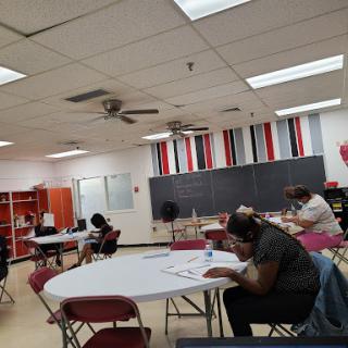 A classroom setting where students are engaged in reading and learning activities.
