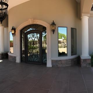 Ornate entrance with columns and lanterns.