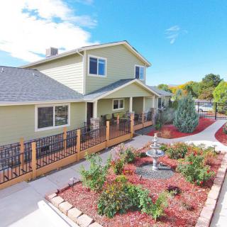 A well-maintained residential house with a landscaped garden and pathway.
