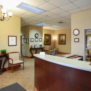 A welcoming office reception area with a desk and seating.