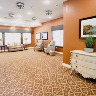A cozy and well-decorated lobby area with comfortable seating, warm lighting, and elegant decor.
