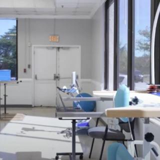 A bright dental office with multiple dentist chairs and large windows.