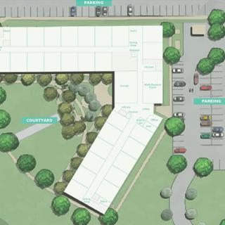 An architectural floor plan showcasing a building layout with surrounding landscaping and parking areas.