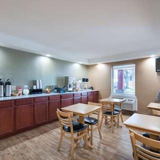 A cozy breakfast area featuring wooden furniture and a coffee station, perfect for casual dining.