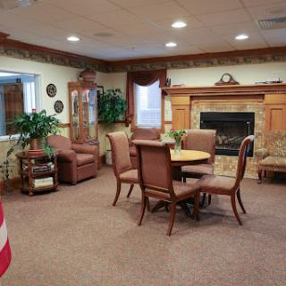 A cozy lounge area featuring comfortable seating and a fireplace.